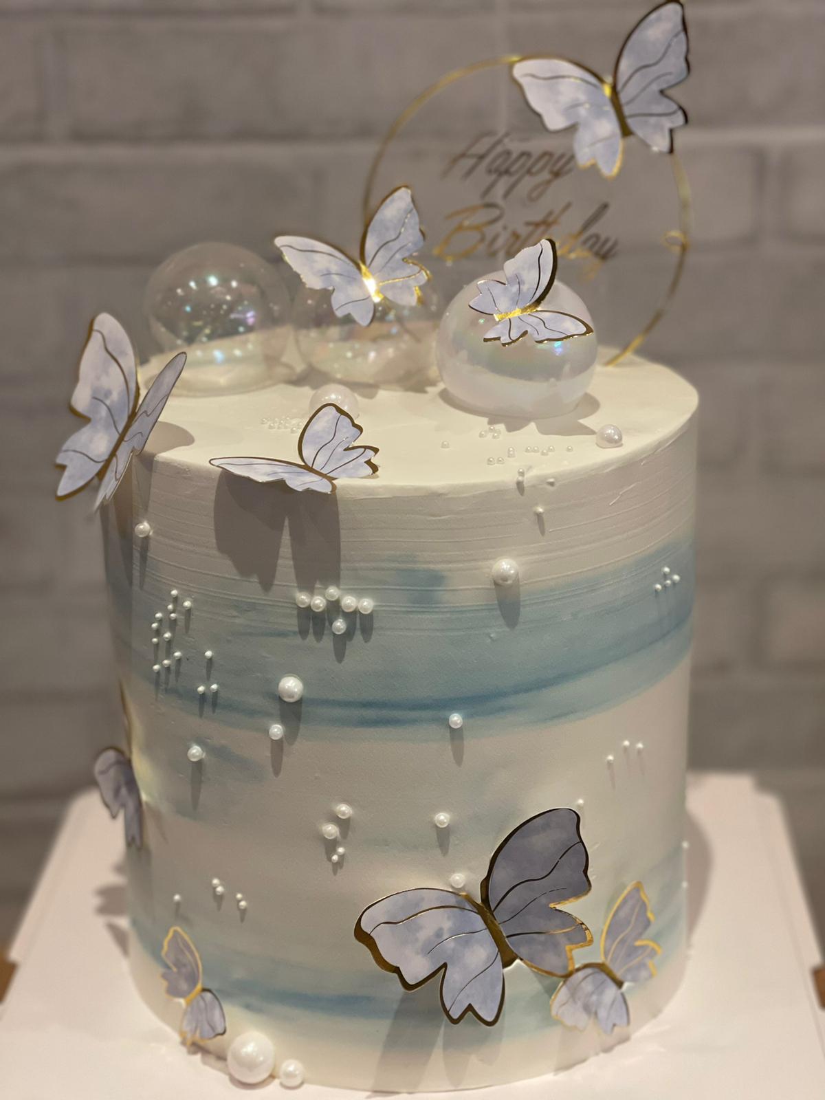 Soft blue cake with sugar butterflies and pearl detailing, La-Luscious Bakery Grays