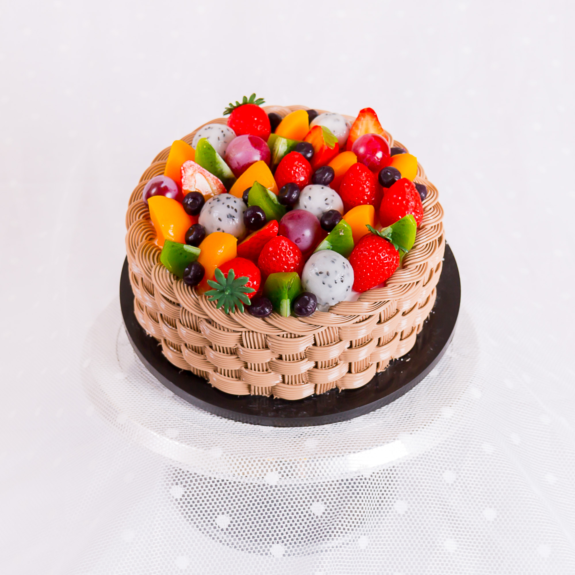Fresh cream basket-weave cake piled with mixed fresh fruit, La-Luscious Bakery Grays