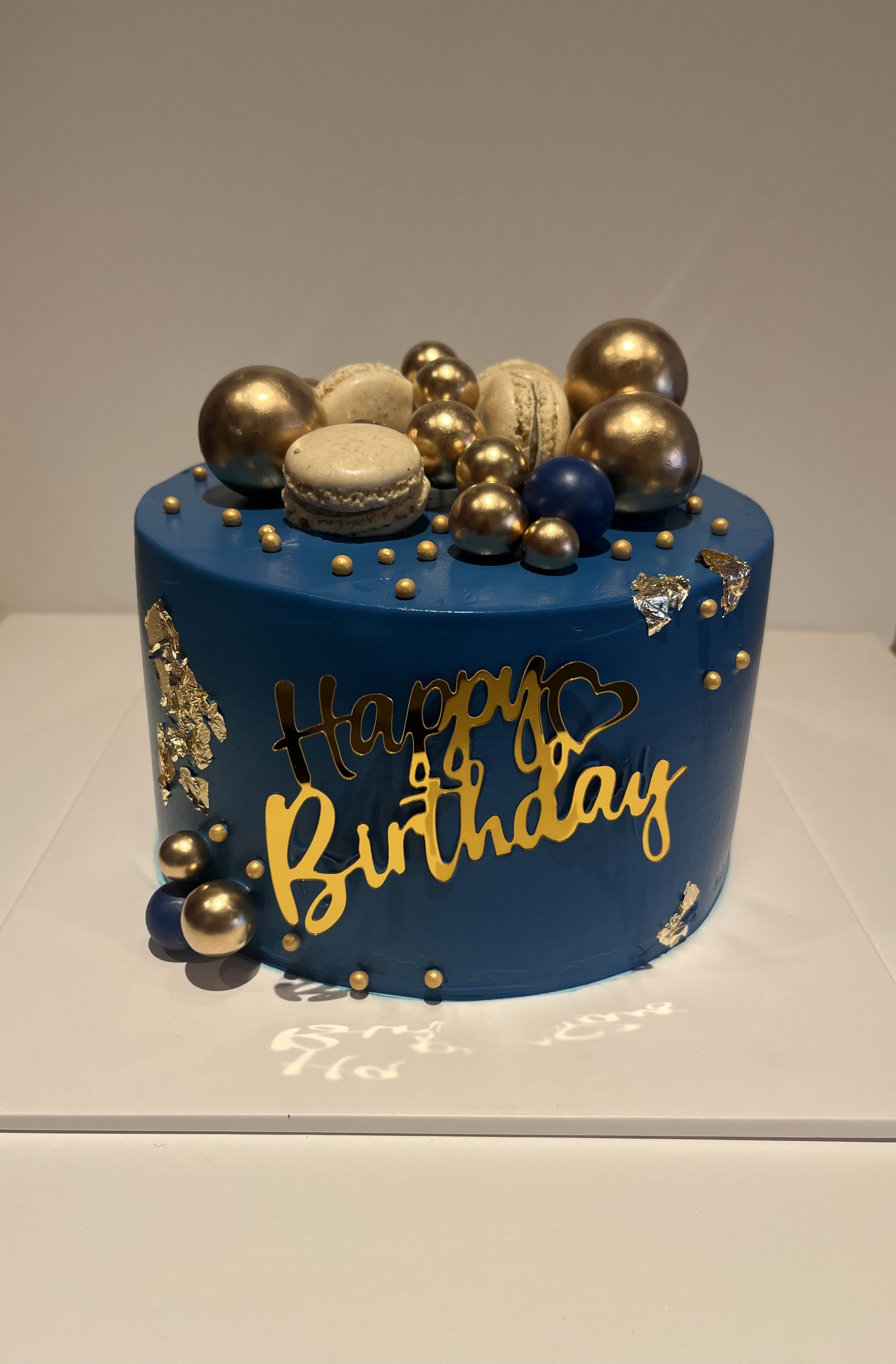Navy blue birthday cake with gold spheres and lettering, La-Luscious Bakery Grays